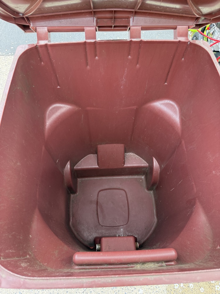 Dirty trash can interior caked with grime before cleaning